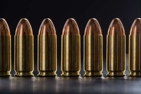 Number pistol cartridge 9 mm caliber on a black backgroundの写真素材