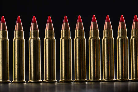 Cartridges ranked with red tip on a black backgroundの写真素材