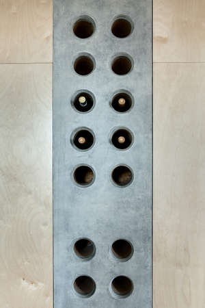 Several bottles of wine in a special concrete hole in the wall  the kitchen to store them. Fragment...
