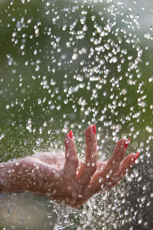 Fresh water falling on a women's hands
