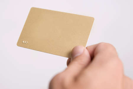 mans hand is holding empty vip cardの写真素材