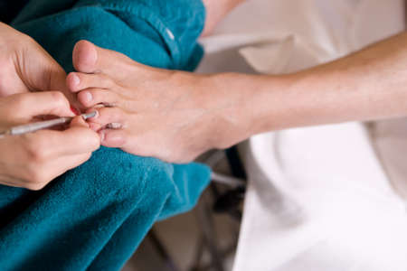 a man and  the procedure of pedicureの写真素材