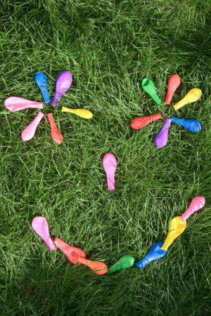 rainbow smile make with a lot of coloured balloonsの写真素材