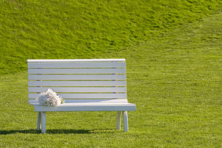 white wedding bench on the green grassの写真素材