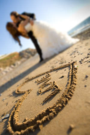 happy wedding couple is kissing on the seasideの写真素材
