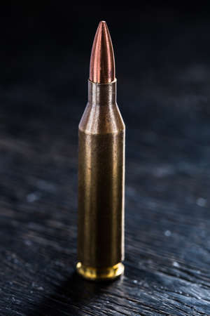 One bullet for a machine gun on a black backgroundの写真素材