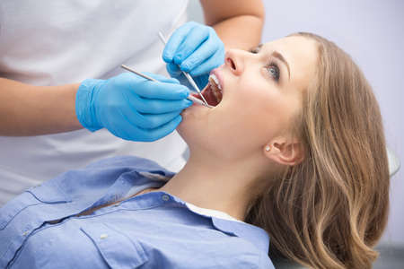 Girl with beautiful white teeth on reception at the doctor dentist.