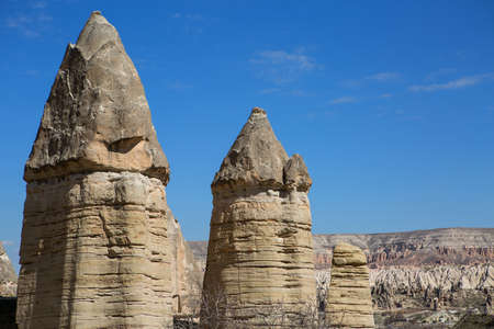 Rock formation on the blue sky with several clouds background. Rocks have jagged peaks.の写真素材