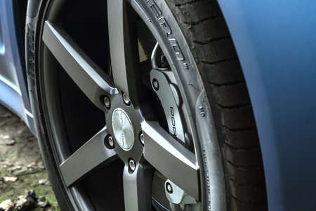 Kiev, Ukraine - 14 May 2014: Porsche Panamera 4S tuning sport-car. It colored in blue matte color. Editorial photo. Closeup view of the wheel.のeditorial素材