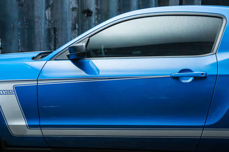 Kiev, Ukraine - 14 May 2014: Ford Mustang tuning sport-car. It colored in blue color with white stripes. Editorial photo. Shoot from the side. Closeup.のeditorial素材