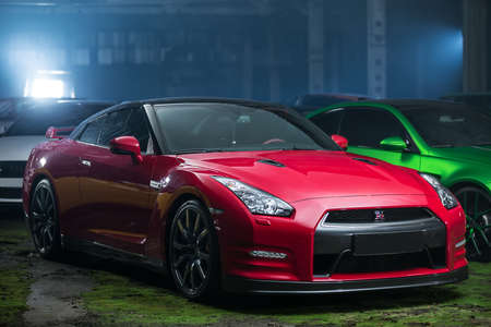 Kiev, Ukraine - 14 May 2014: Nissan GT-R tuning sport-car on the background of other autos. It colored in red and black colors. Editorial photo.のeditorial素材
