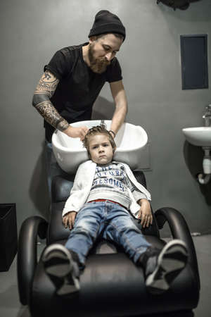 Small boy in barbershopの写真素材