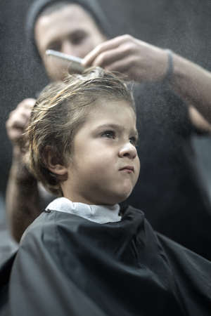 Small boy in barbershopの写真素材