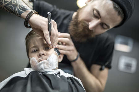 Humorous shaving of little boyの写真素材
