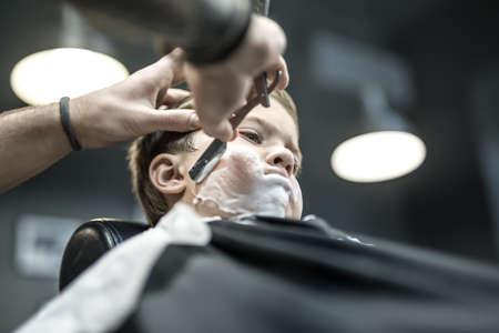 Humorous shaving of little boyの写真素材