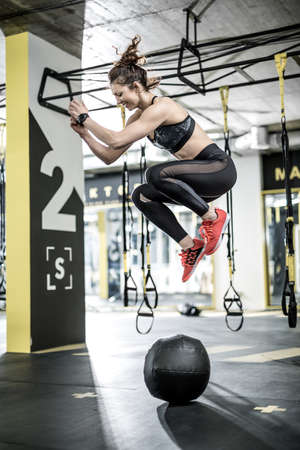 Jumping active woman in gymの写真素材