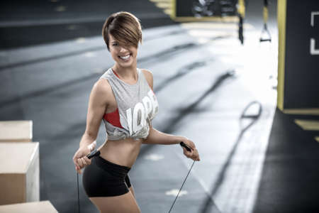 Sportive girl does exercise in gymの写真素材