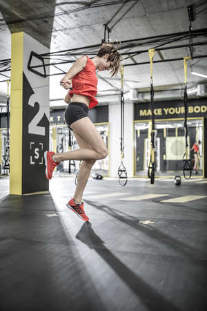 Sportive girl does exercise in gymの写真素材