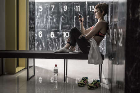 Sportive girl relaxing after trainingの写真素材