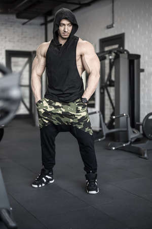 Strong man posing in gymの写真素材