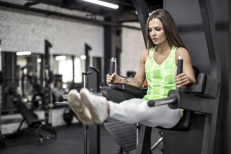 Training of athletic girl in gym