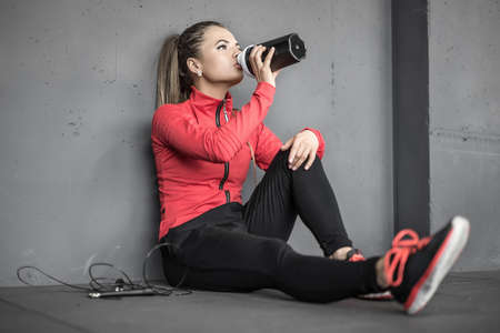 Sportive girl relaxing in gymの写真素材