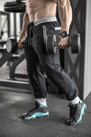 Topless man with with dumbbellsの写真素材
