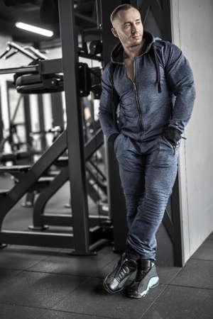 Muscular man posing in gymの写真素材