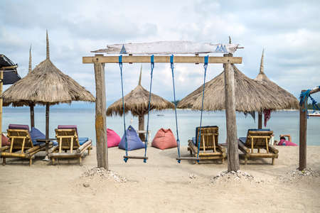 Beach with swing and sunbedsの写真素材
