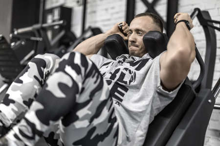 Brutal mans workout in gymの写真素材