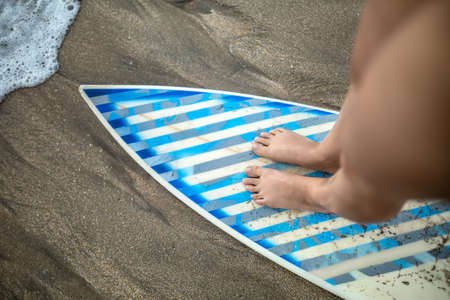 Female legs on surfboardの写真素材