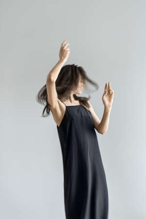 Girl posing in motion in studioの写真素材