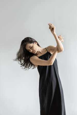 Girl posing in motion in studioの写真素材
