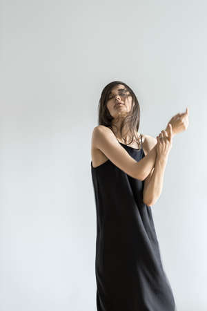 Girl posing in motion in studioの写真素材