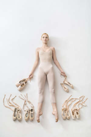 Blonde ballerina lies in studioの写真素材