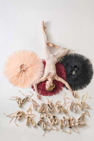 Blonde ballerina lies in studioの写真素材