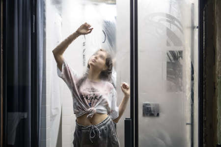 Woman is drawing on glass doorの写真素材