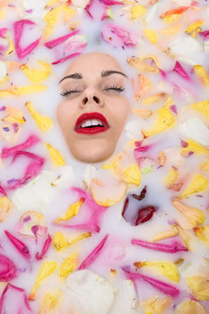 Tattooed girl relaxing in bathの写真素材