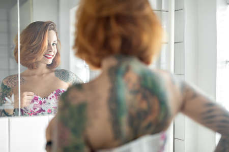 Tattooed girl in bathroomの写真素材
