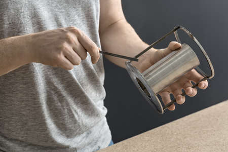 Man with cylindrical metal constructionの写真素材