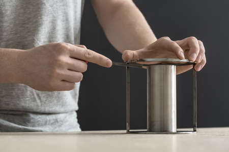 Man with cylindrical metal constructionの写真素材