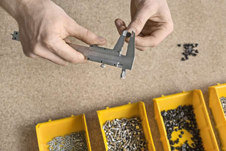 Man using caliper in workshopの写真素材