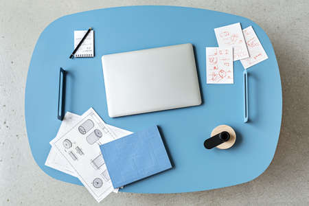 Blue table with laptopの写真素材