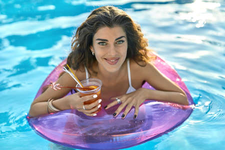 Model in swimming pool outdoorsの写真素材