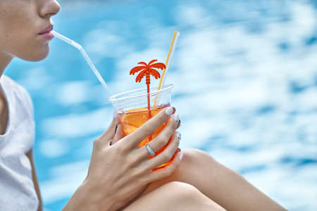 Model drinking orange cocktailの写真素材