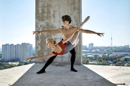 Ballet dancers posing at unfinished buildingの写真素材