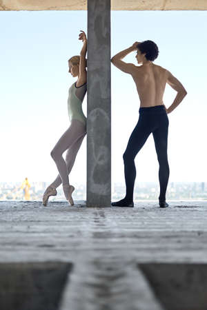 Ballet dancers posing at unfinished buildingの写真素材