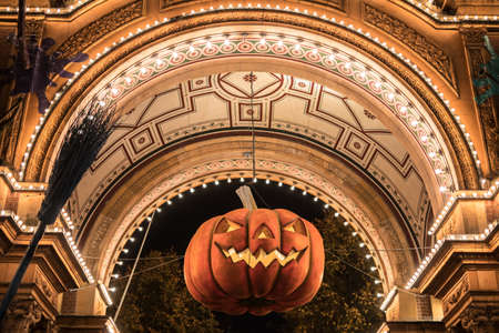 Big Halloween pumpkin hanging in archwayの写真素材