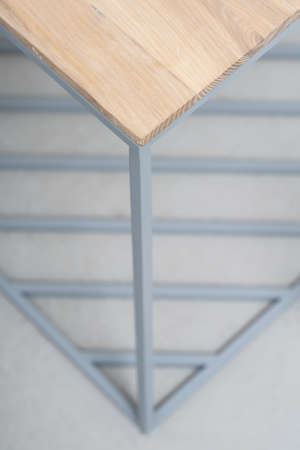 Wooden-metallic stand on the gray floor in the studio. Closeup vertical photo.の写真素材