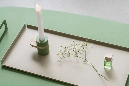 Burning candlestick on metal trayの写真素材